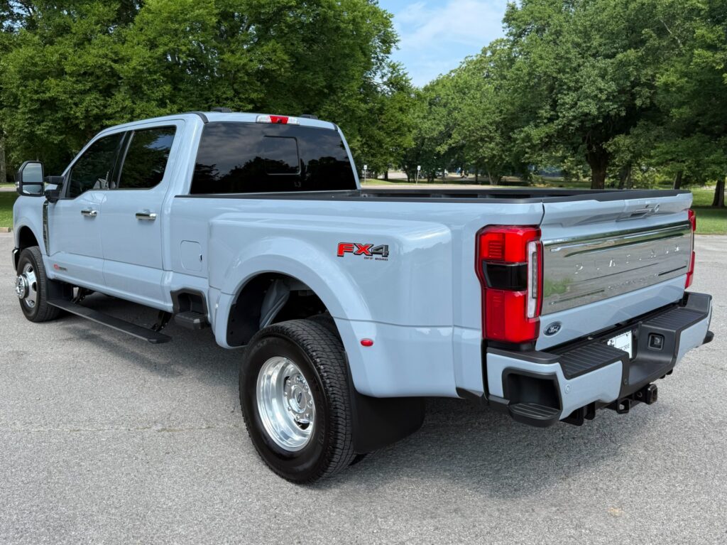 Rear three-quarter view of a 2024 Ford F-350 Super Duty Platinum FX4 Off-Road in white with chrome accents