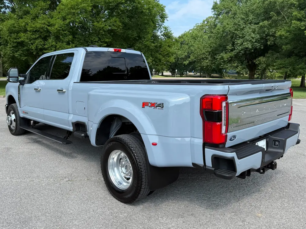 Rear angle of a 2024 Ford F-350 Super Duty Platinum FX4 Off-Road Package in Iconic Silver.