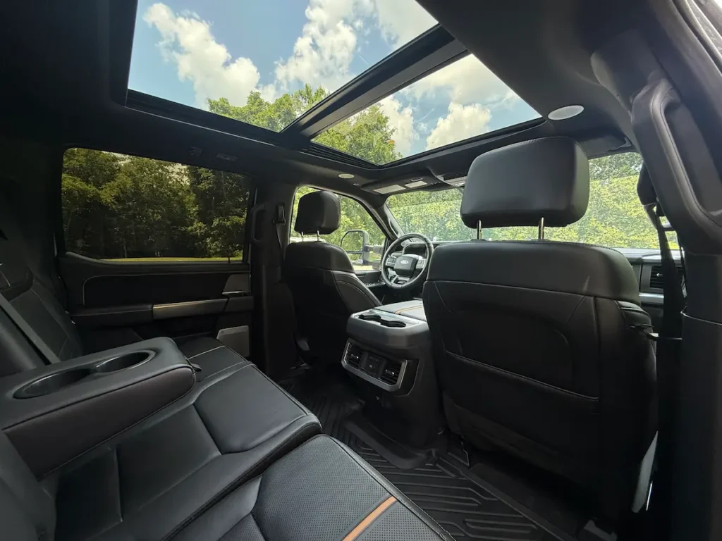 Interior of 2024 Ford F-350 Platinum Super Duty showing panoramic moonroof and rear seating.