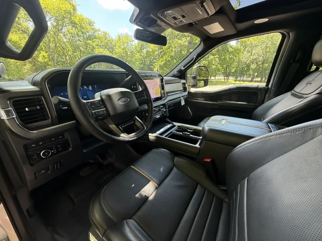 Driver’s cockpit of 2024 Ford F-350 Platinum Super Duty featuring digital dashboard and SYNC 4 touchscreen.