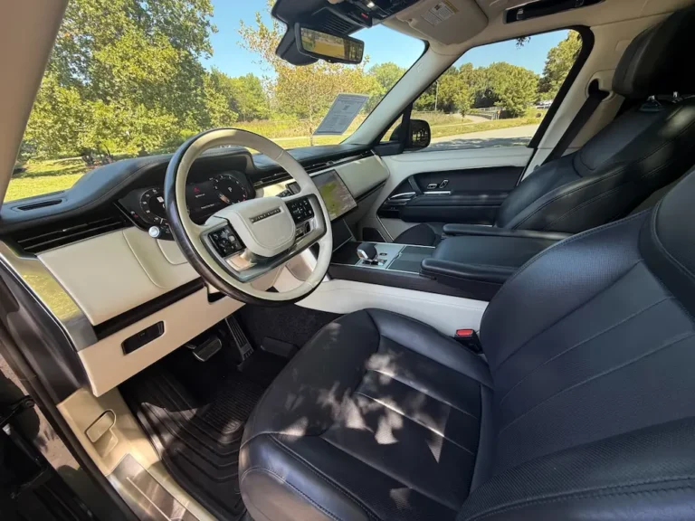 Range Rover SUV interior front cabin with leather seats, digital display, and luxury finishes