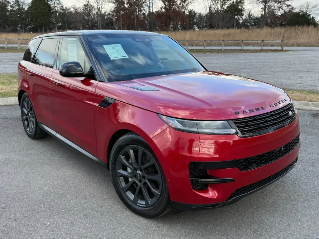 2024 Land Rover Range Rover Sport P360 SE in red with black roof, front exterior view.