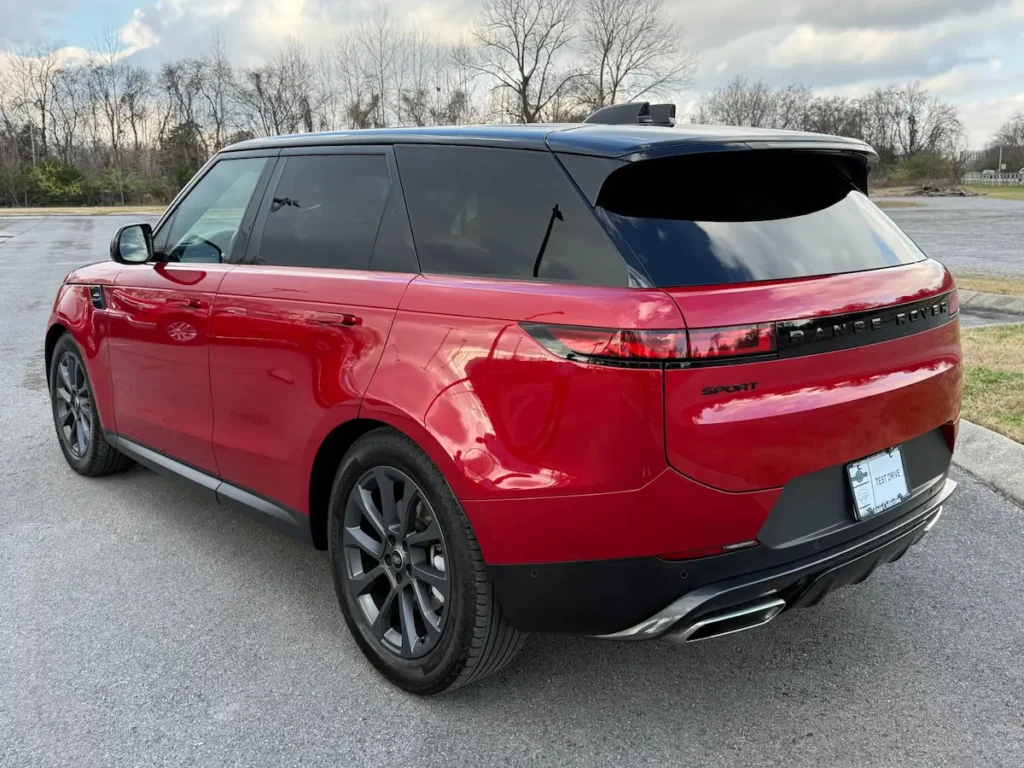 Rear view of 2024 Range Rover Sport P360 SE in red with black roof.