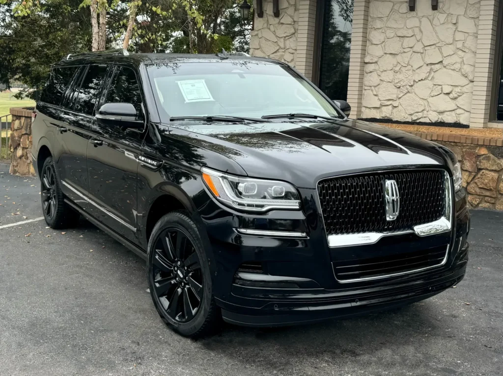 Black Monochromatic 2024 Lincoln Navigator Reserve L parked outdoors, showcasing its sleek design and premium finish.