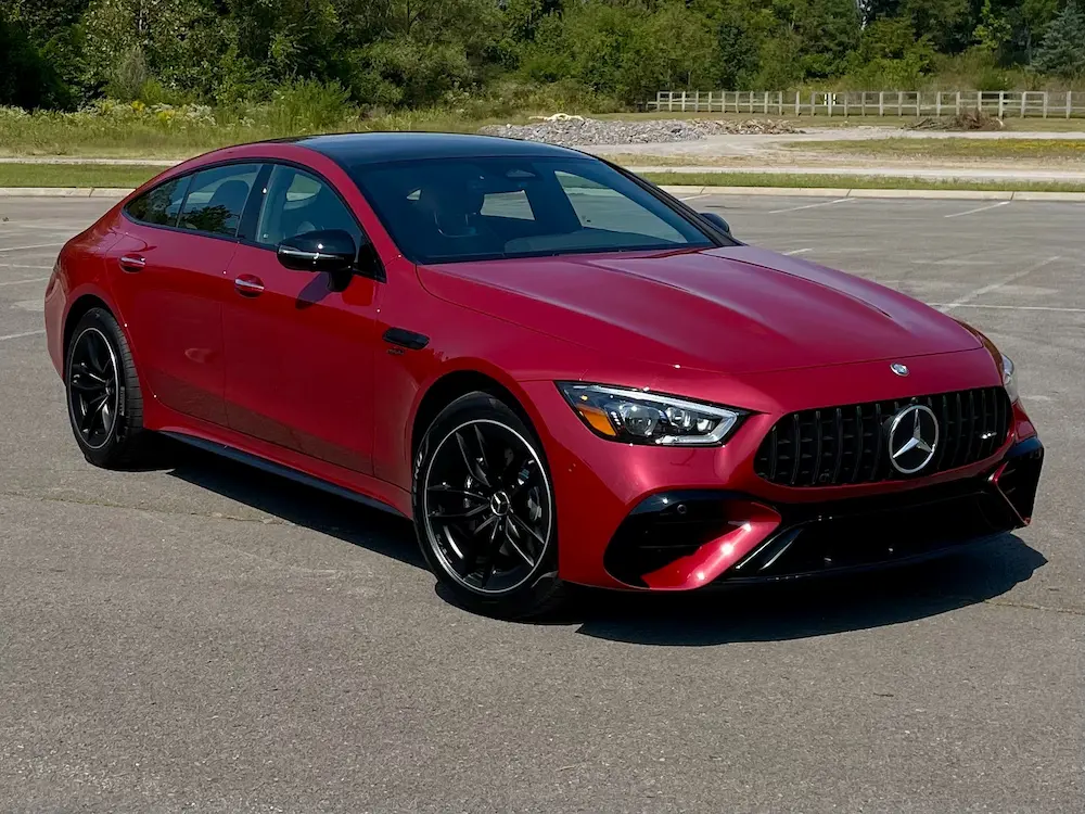 2024 Mercedes-AMG GT 43 4-Door Coupe in red showcasing AMG grille and performance styling.