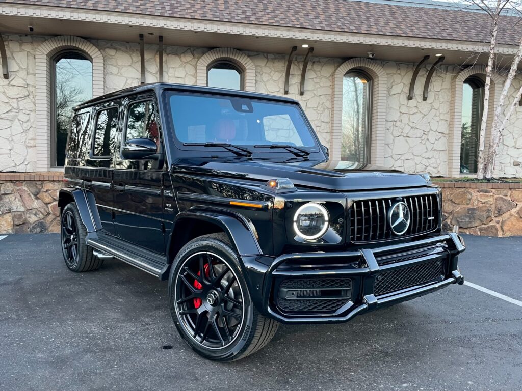 A lone black Mercedes-Benz G63 AMG SUV gleams in the AutoPro Nashville parking lot, showcasing its power and luxury.