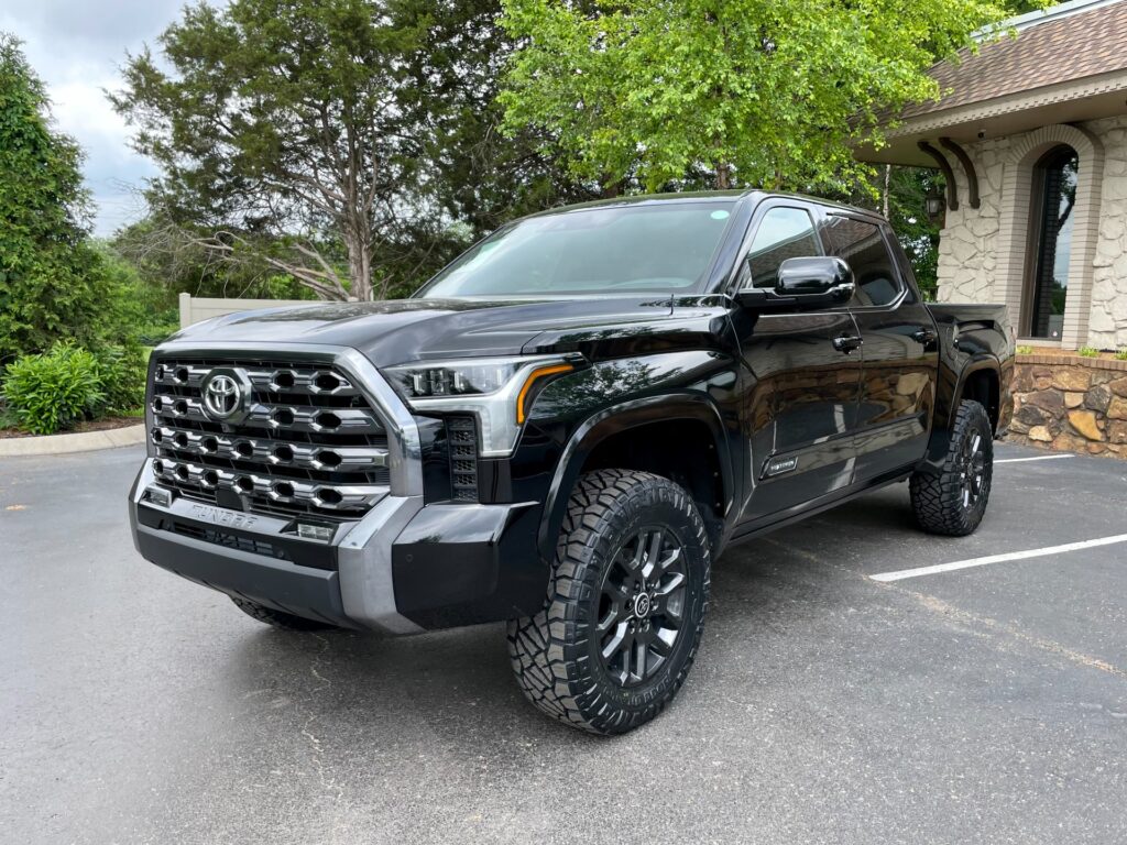 Used 2024 Toyota Tundra Platinum Crew Cab with Power Running Boards parked outside AutoPro Nashville, a used car dealership.