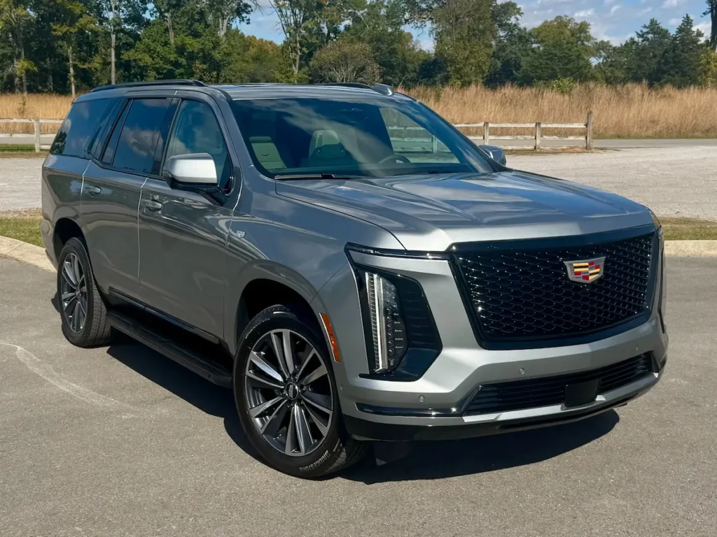 2025 Cadillac Escalade Sport front three-quarter view showing bold grille, LED lighting, and polished silver finish.