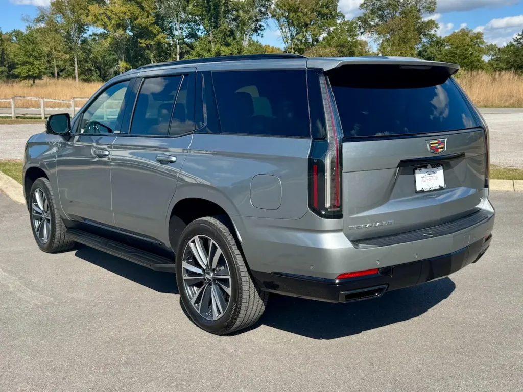 2025 Cadillac Escalade Sport rear view featuring LED taillights, gloss-black trim, and sporty proportions.