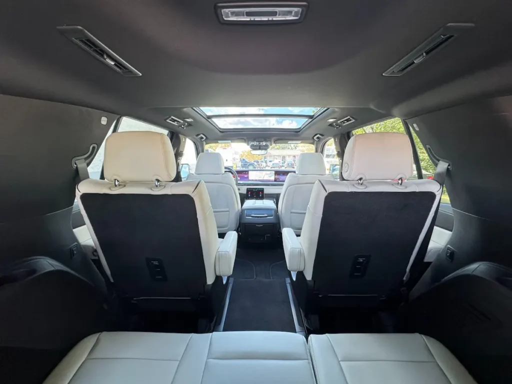 2025 Cadillac Escalade Sport second-row seating featuring white leather upholstery and panoramic sunroof.