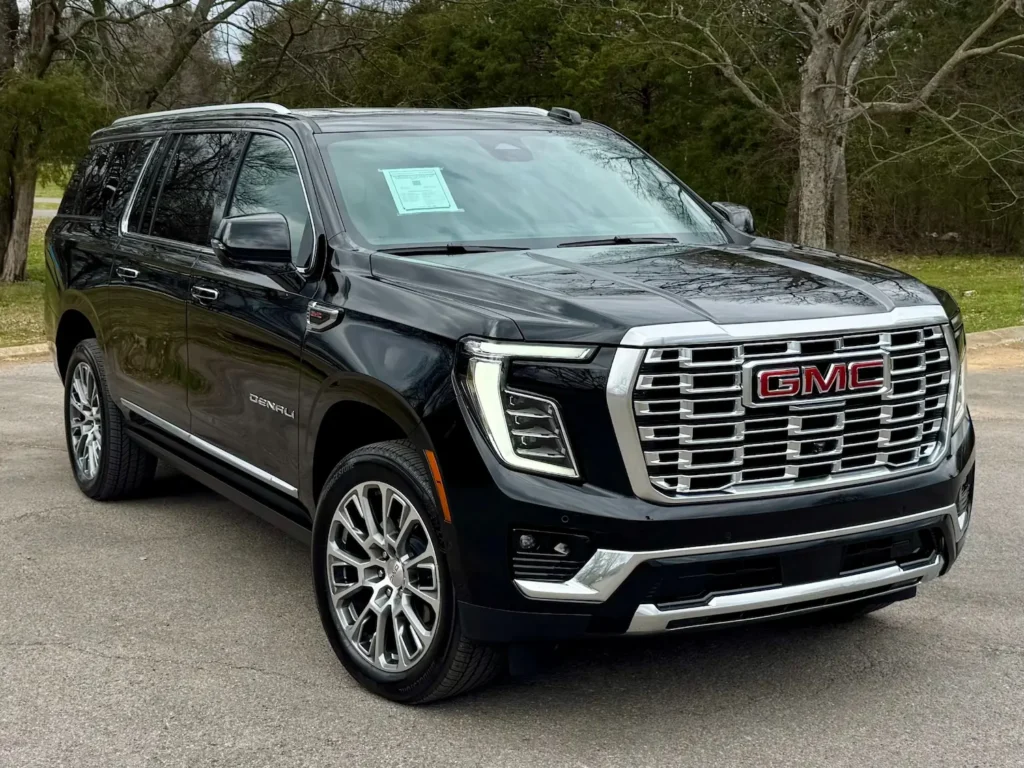 xterior front view of a used 2025 GMC Yukon XL Denali with Sun and Power Step Package and 22-inch wheels.