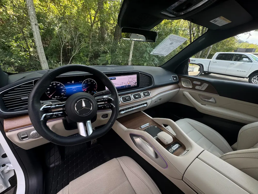 Interior of 2025 Mercedes-Benz GLS 450 4MATIC showcasing digital cockpit, wood trim, and Nappa leather seats.