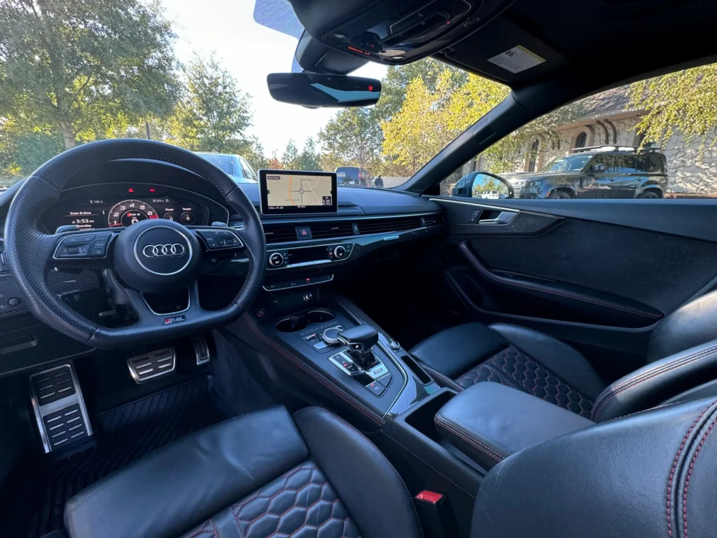 Interior of 2018 Audi RS5 at AutoPro Nashville, featuring premium leather seats, sporty steering wheel, and advanced technology.