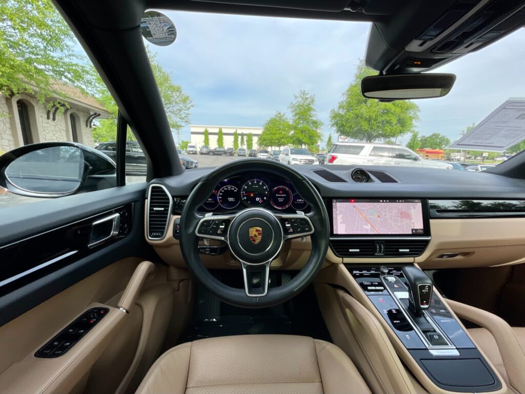 Interior view of a pre-owned 2021 Porsche Cayenne AWD with a panoramic roof at AutoPro Nashville.