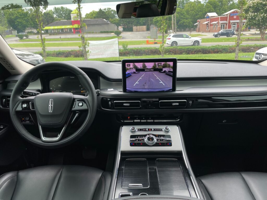 View of a modern Lincoln Aviator dashboard featuring a rearview camera display and a luxurious leather interior. Photo taken at AutoPro Nashville.