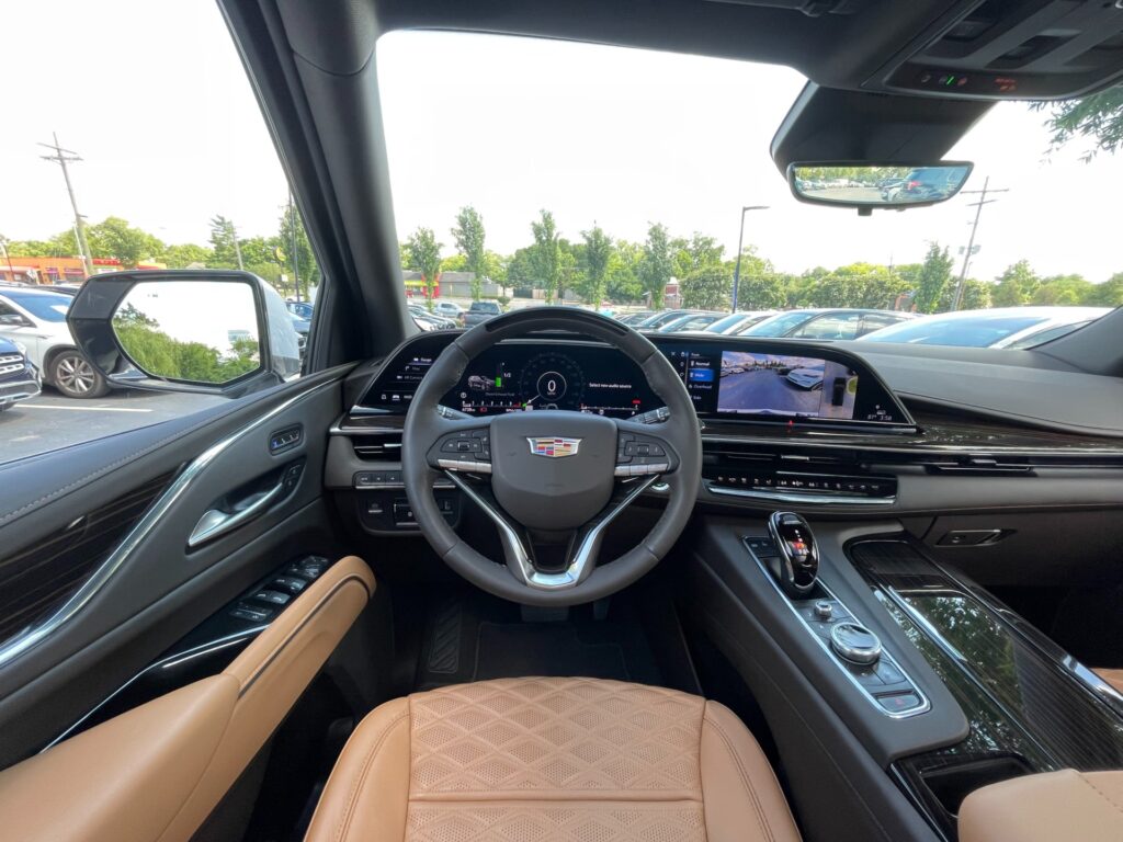 Interior view of a 2024 Cadillac Escalade SPORT 4WD showing the dashboard and leather seats.