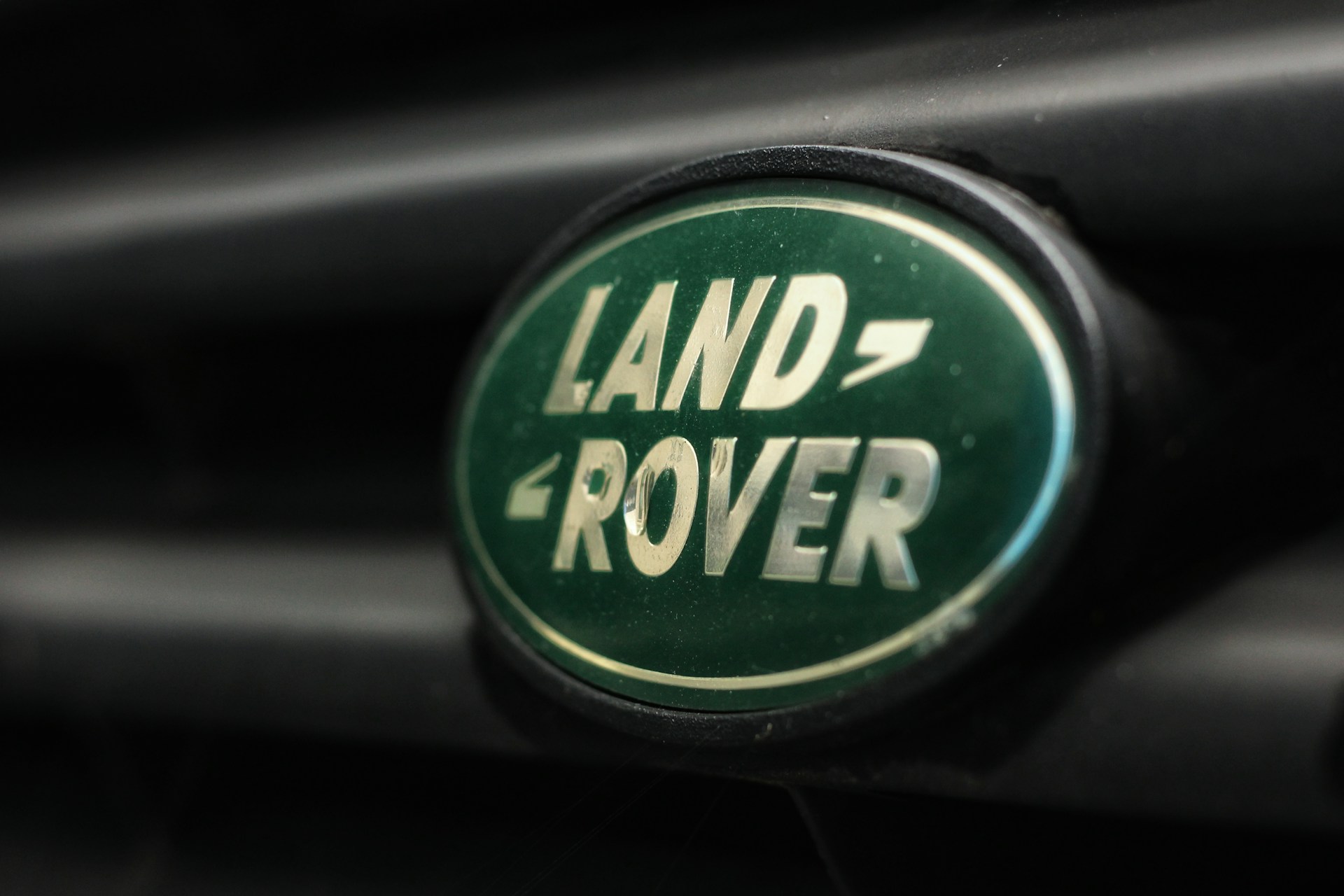 Close-up image of the Land Rover logo, featuring the words "LAND" above "ROVER" in a bold, serif font.