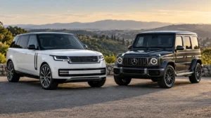 White Range Rover and dark Mercedes-Benz G-Wagon parked side by side, overlooking rolling hills at sunset.